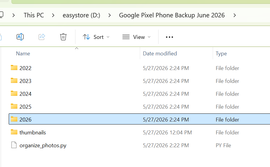 File Explorer showing root backup directory organized into Year folders (2022 to 2026), placeholders, and the python script