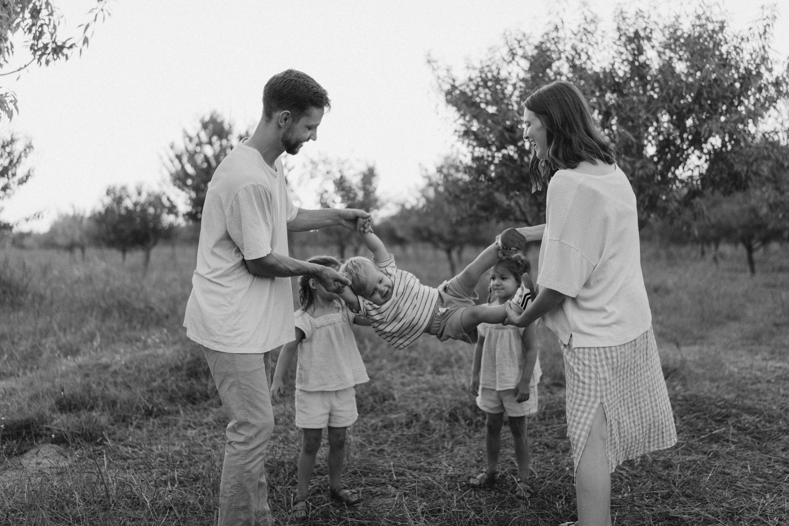 Family playing in grassy field